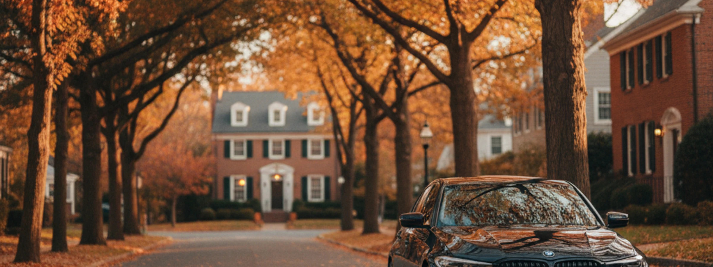 BMW 3 Series parked on a tree-lined Princeton street in autumn
