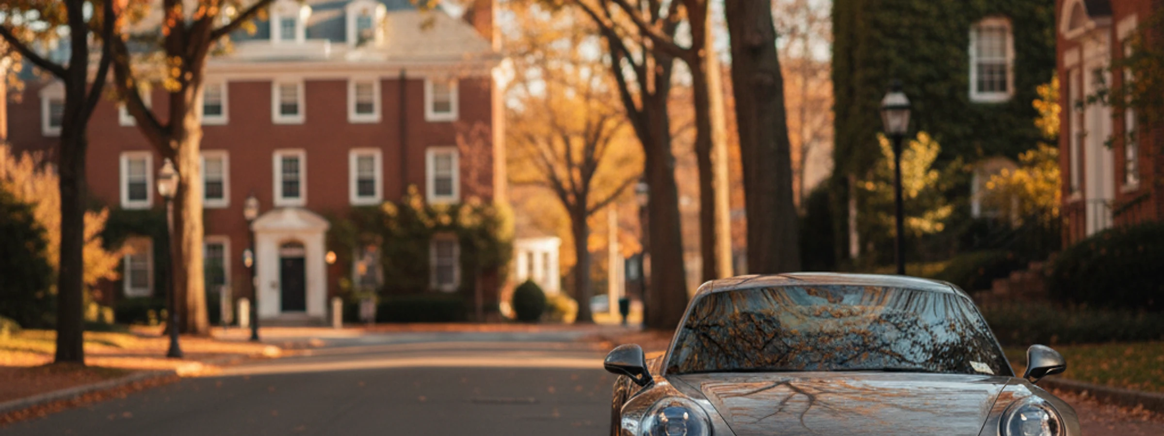 Porsche 911 parked along an ivy-lined Princeton residential street